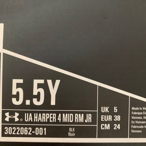 Youth size 5.5 under Armor football cleats.
